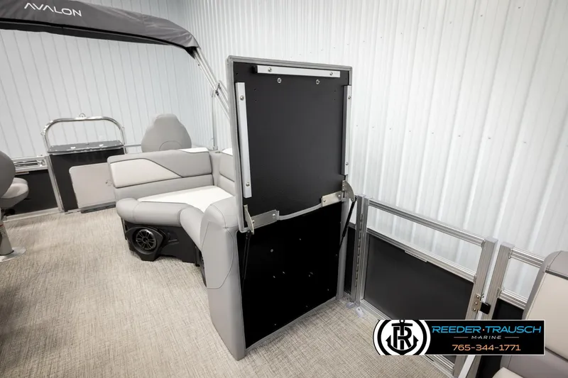 Slide: The Image of 2026 Avalon VEN RF boat interior with seating and storage, Reeder-Trausch Marine branding. - 23