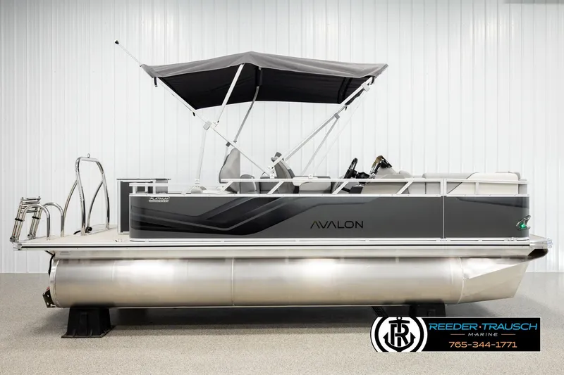 Slide: The Image of 2026 Avalon VEN RF pontoon boat with canopy, displayed indoors at Reeder-Trausch Marine. - 5