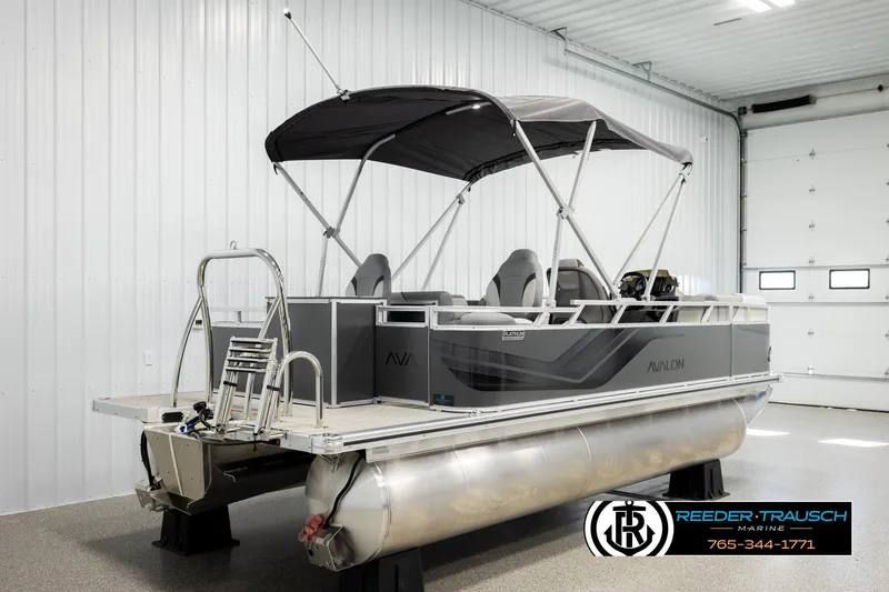 Slide: The Image of 2026 Avalon VEN RF pontoon boat in showroom, featuring sleek design and canopy. - 6