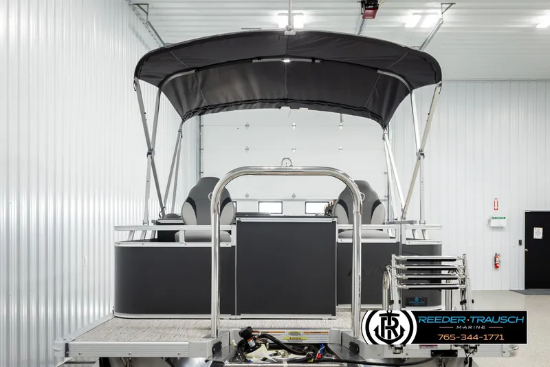 Slide: The Image of 2026 Avalon VEN RF pontoon boat in a showroom with canopy and ladder. - 7
