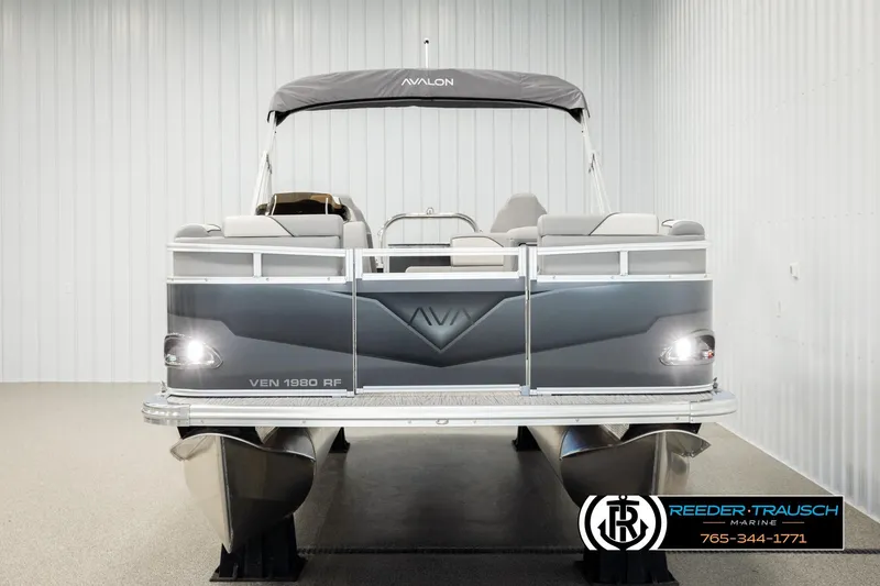 Slide: The Image of 2026 Avalon VEN RF pontoon boat in showroom, front view with sleek design. - 8