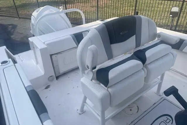 Slide: The Image of 2024 Robalo R230 Center Console boat interior with cushioned seating and storage. - 4