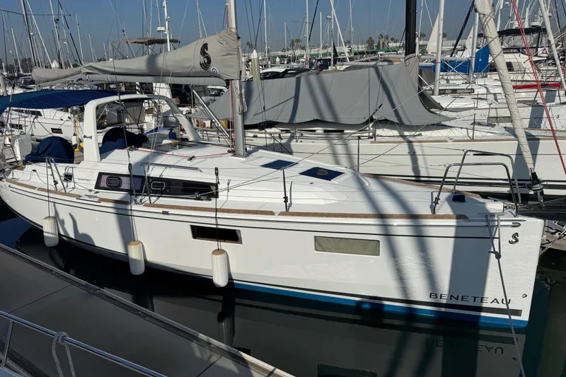 Slide: The Image of 2021 Beneteau Oceanis 35.1 sailboat docked in marina, surrounded by other boats. - 1