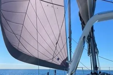 Slide: The Image of Sailing on a 2021 Beneteau Oceanis 35.1 with full sails against a clear blue sky. - 10