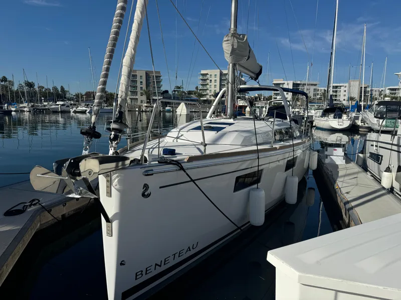 Slide: The Image of 2021 Beneteau Oceanis 35.1 sailboat docked in a marina under clear skies. - 11