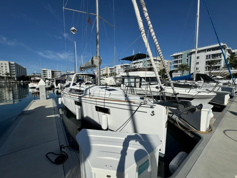 Slide: The Image of Beneteau Oceanis 35.1 sailboat docked at marina, 2021 model, clear blue sky. - 12