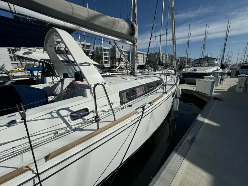 Slide: The Image of 2021 Beneteau Oceanis 35.1 sailboat docked at a marina under clear skies. - 15