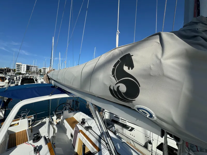 Slide: The Image of Beneteau Oceanis 35.1 sailboat, 2021 model, docked in marina with visible sail cover. - 23