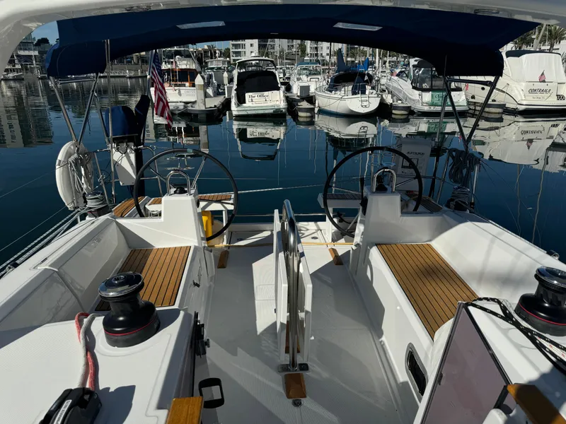 Slide: The Image of 2021 Beneteau Oceanis 35.1 sailboat cockpit with dual steering wheels in marina. - 24