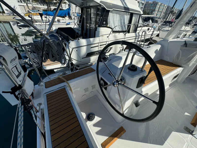 Slide: The Image of 2021 Beneteau Oceanis 35.1 yacht cockpit with steering wheel and teak seating. - 25