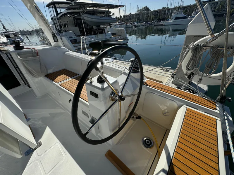 Slide: The Image of Cockpit of 2021 Beneteau Oceanis 35.1 sailboat with steering wheel, docked at marina. - 26