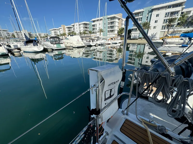 Slide: The Image of Beneteau Oceanis 35.1 sailboat docked in a marina, surrounded by modern buildings, 2021 model. - 28
