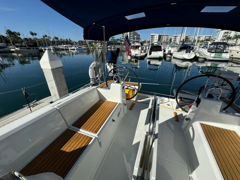 Slide: The Image of Beneteau Oceanis 35.1 sailboat cockpit, 2021 model, docked in a marina with clear skies. - 32