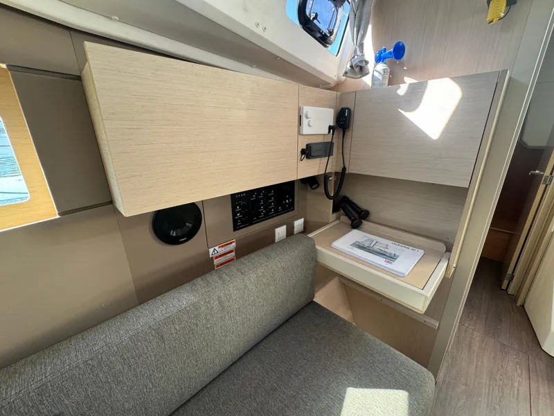 Slide: The Image of Interior of 2021 Beneteau Oceanis 35.1 yacht with seating and navigation station. - 46