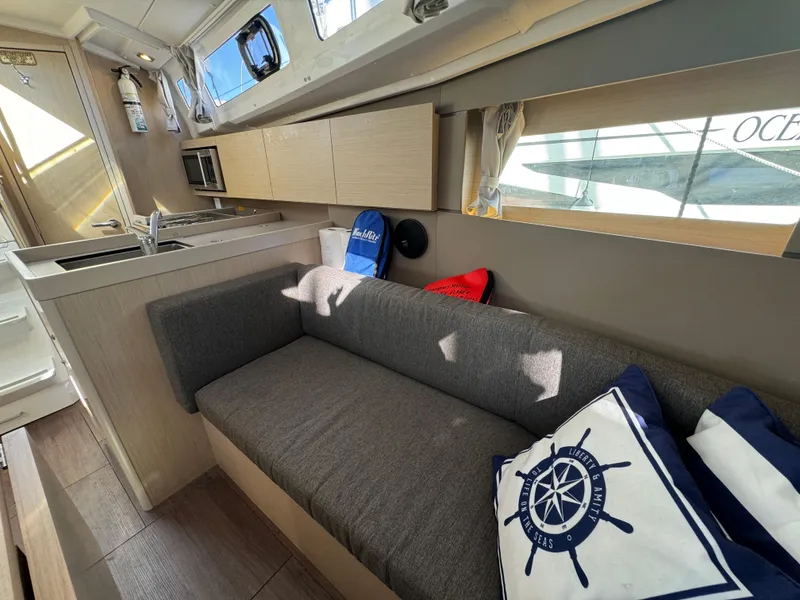 Slide: The Image of Interior of 2021 Beneteau Oceanis 35.1 yacht with modern kitchen and cozy seating area. - 48