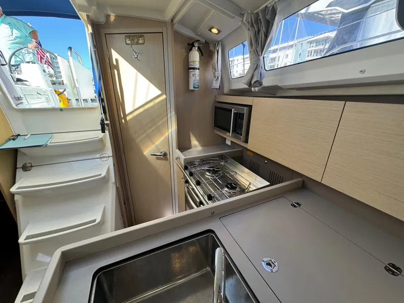 Slide: The Image of Modern kitchen interior of 2021 Beneteau Oceanis 35.1 yacht with stove and sink. - 50