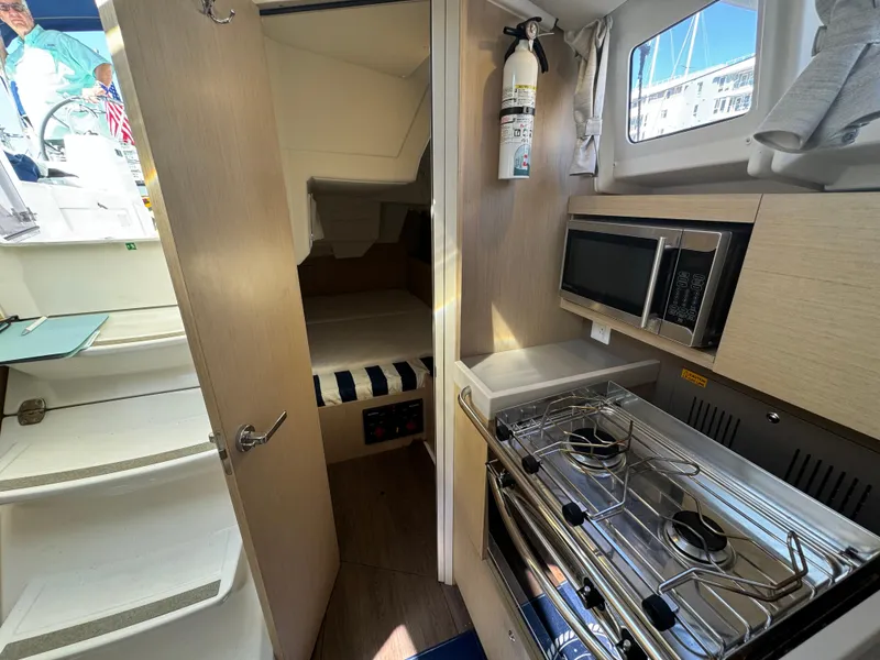Slide: The Image of Interior of 2021 Beneteau Oceanis 35.1 yacht with kitchen and sleeping area. - 51
