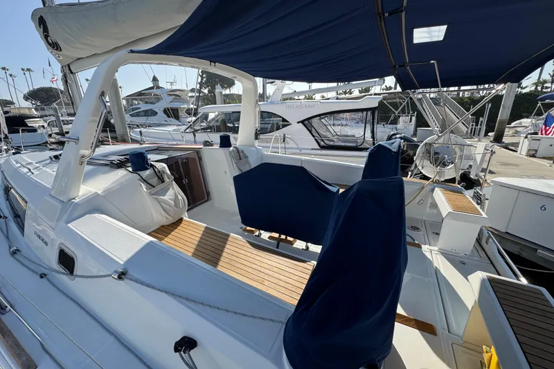 Slide: The Image of 2021 Beneteau Oceanis 35.1 sailboat with blue canopy, docked at marina. - 59