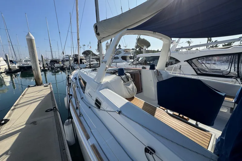 Slide: The Image of 2021 Beneteau Oceanis 35.1 yacht docked at marina, showcasing sleek design and spacious deck. - 60