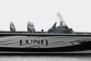 The Image of 2026 Lund 1875 Impact XS SS boat on trailer outside dealership. - 0