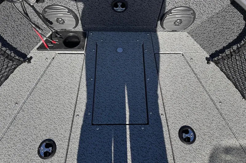 Slide: The Image of 2026 Lund 1875 Impact XS SS boat interior with storage compartments and speakers. - 15