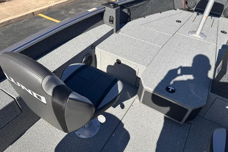 Slide: The Image of 2026 Lund 1875 Impact XS SS boat interior with seating and storage compartments. - 18