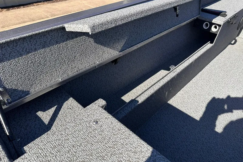 Slide: The Image of 2026 Lund 1875 Impact XS SS boat interior with storage compartments. - 19