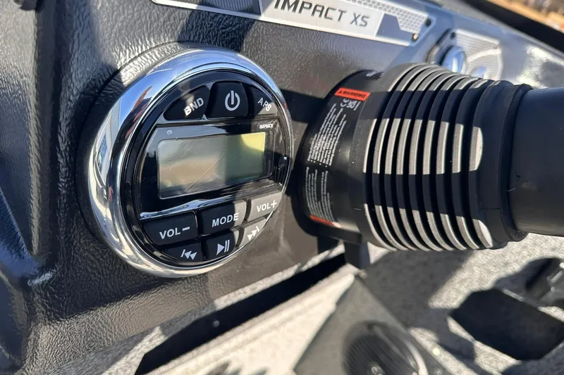 Slide: The Image of Control panel of 2026 Lund 1875 Impact XS SS boat, featuring audio system controls. - 22