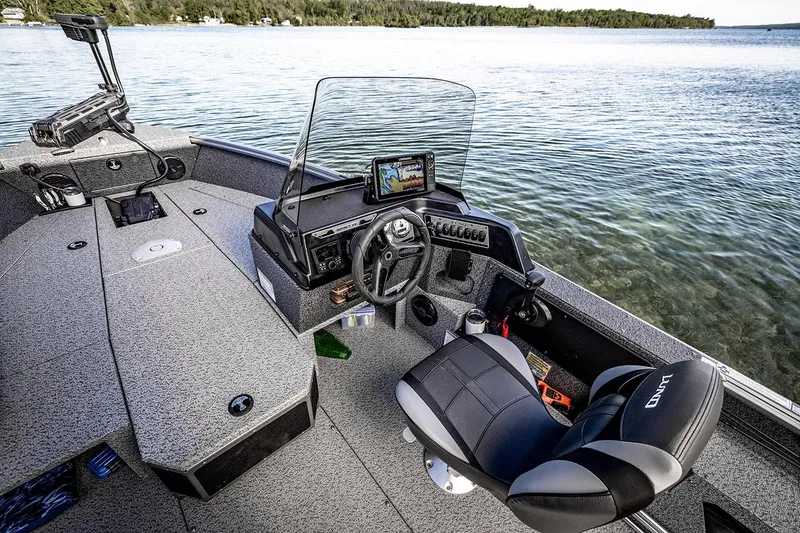 Slide: The Image of 2026 Lund 1875 Impact XS SS boat interior with steering console and seating. - 7