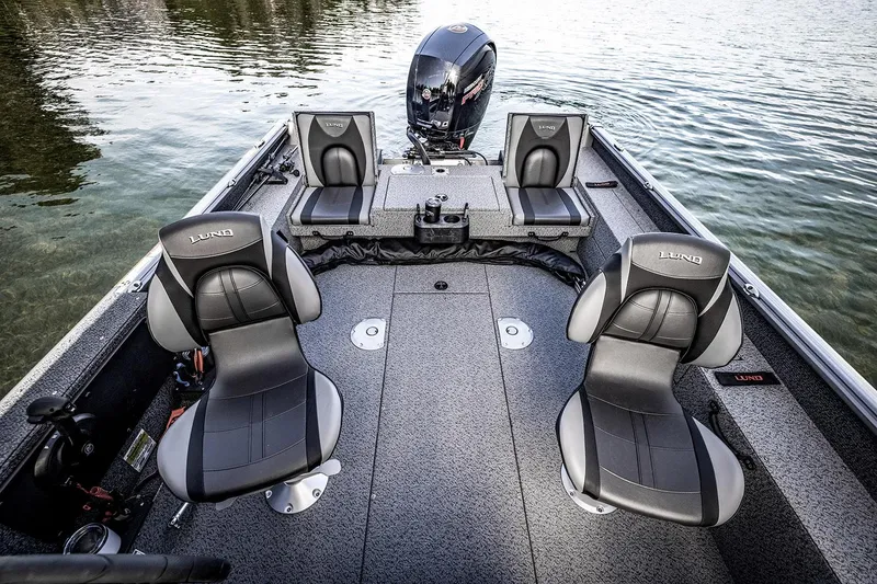 Slide: The Image of 2026 Lund 1875 Impact XS SS boat interior with steering wheel and seating. - 8