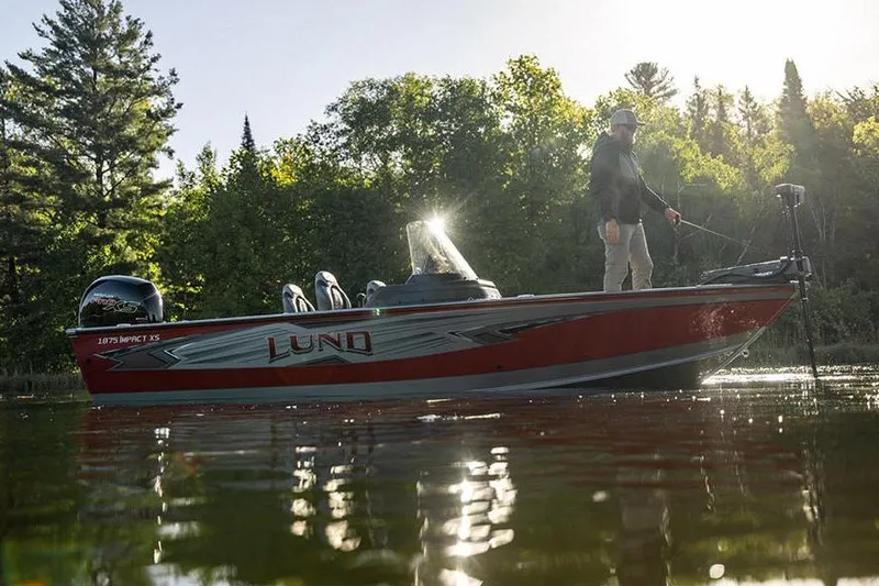 Slide: The Image of 2026 Lund 1875 Impact XS SS boat interior with four black seats. - 9