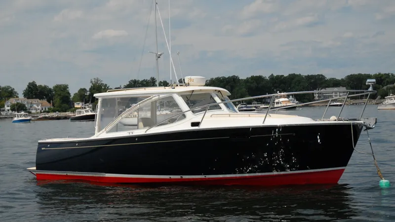 The Image of 2007 MJM 29z boat on calm water with a scenic background. - 0