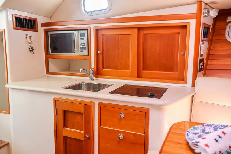 Slide: The Image of 2007 MJM 29z boat kitchen with microwave, sink, and stove. - 20