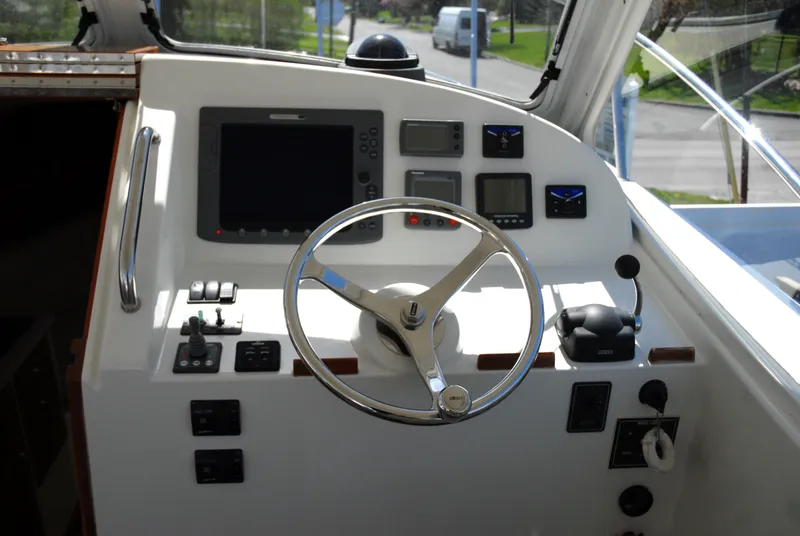 Slide: The Image of Helm station of a 2007 MJM 29z boat with steering wheel and navigation instruments. - 6