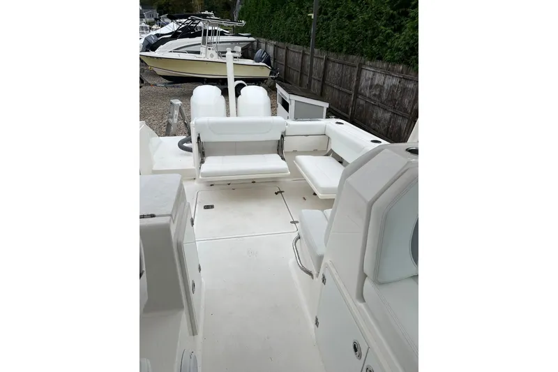 Slide: The Image of 2020 Pursuit DC 266 Dual Console boat interior with white seating and spacious layout. - 12
