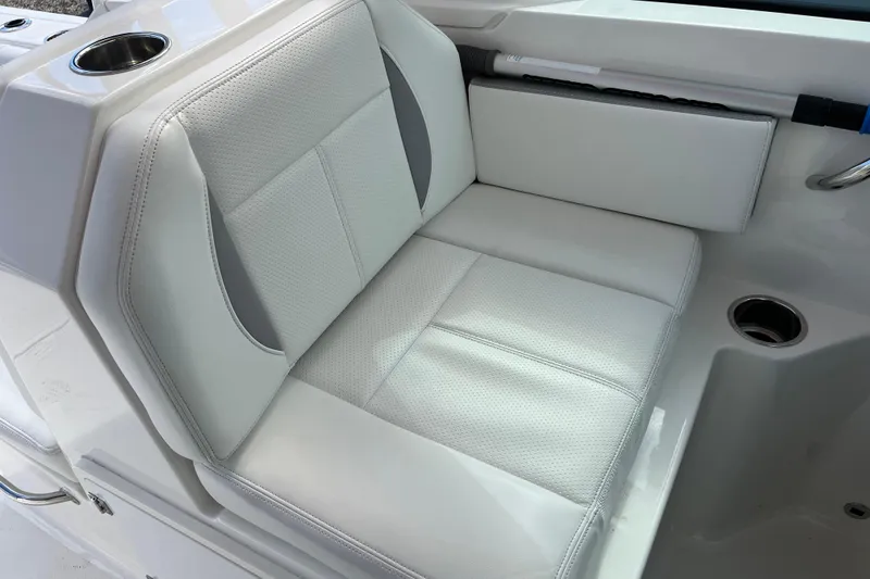 Slide: The Image of 2020 Pursuit DC 266 Dual Console boat seat with cup holder and white upholstery. - 13