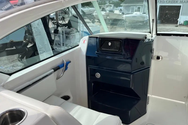 Slide: The Image of 2020 Pursuit DC 266 Dual Console interior with seating and storage compartments. - 16