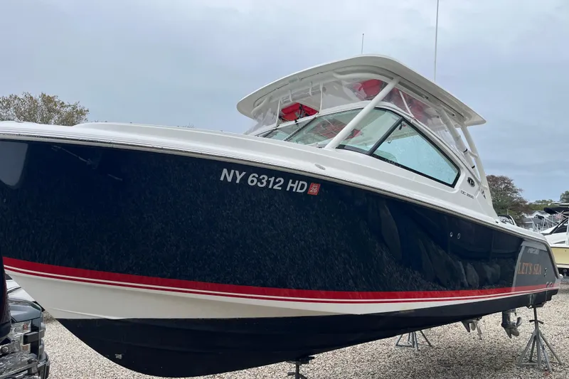 Slide: The Image of 2020 Pursuit DC 266 Dual Console boat on display, featuring sleek design and NY registration. - 2