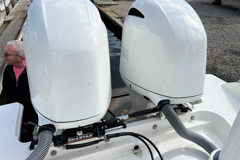 Slide: The Image of 2020 Pursuit DC 266 Dual Console with twin Yamaha outboard engines at dockside. - 22