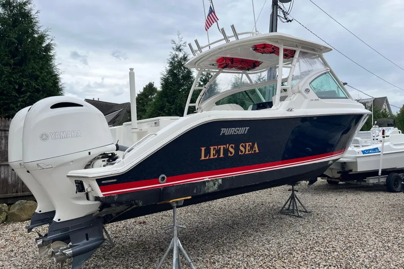 Slide: The Image of 2020 Pursuit DC 266 Dual Console boat with Yamaha engine, named "Let's Sea," on display. - 3