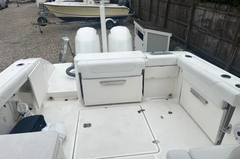 Slide: The Image of 2020 Pursuit DC 266 Dual Console boat interior with seating and storage compartments. - 8