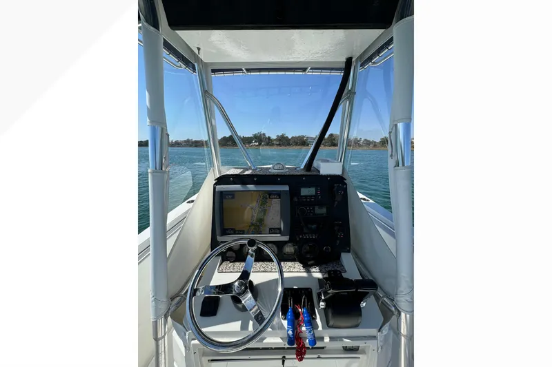 Slide: The Image of 1998 Contender 23 Open boat cockpit with navigation system and steering wheel. - 6