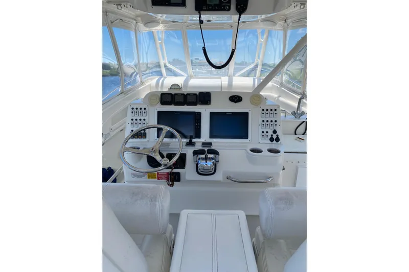 Slide: The Image of Cockpit of 2008 Everglades 350LX boat with steering wheel and navigation screens. - 11