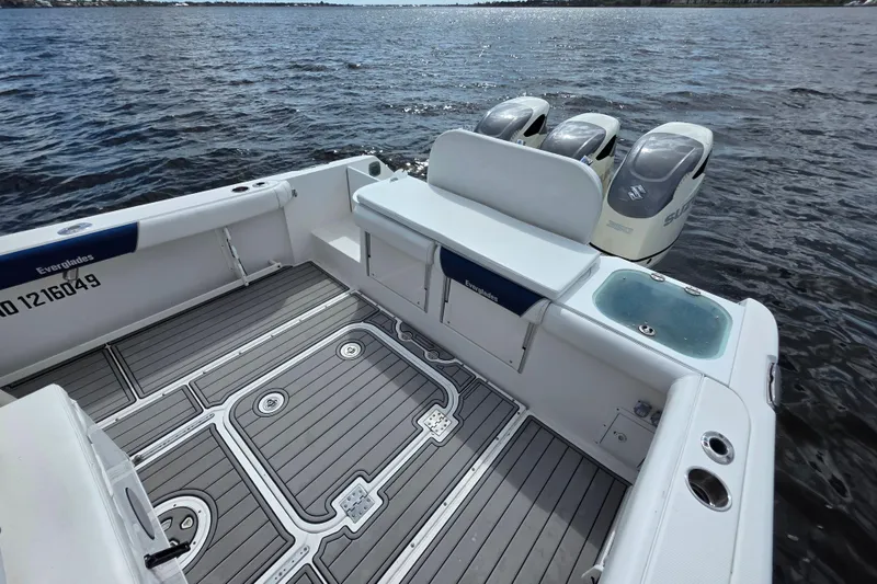Slide: The Image of 2008 Everglades 350LX boat with triple Suzuki engines on open water. - 14