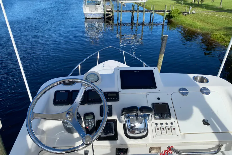 Slide: The Image of Cockpit view of 2008 Everglades 350LX boat with steering wheel and controls. - 16