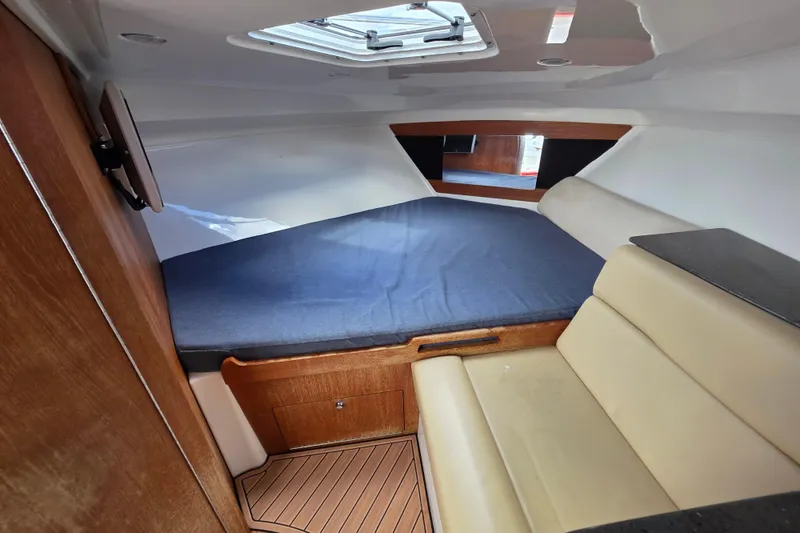 Slide: The Image of 2008 Everglades 350LX cabin interior with bed and seating area. - 29