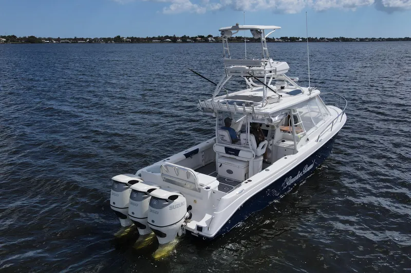 Slide: The Image of 2008 Everglades 350LX boat on water, featuring triple Suzuki engines. - 3