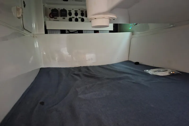 Slide: The Image of 2008 Everglades 350LX cabin interior with control panel and blue bedding. - 30