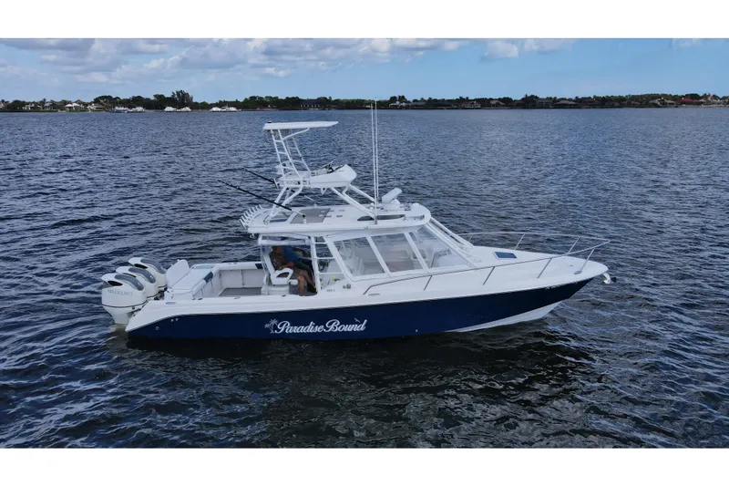 Slide: The Image of 2008 Everglades 350LX boat on water, featuring dual Suzuki engines and "Paradise Bound" text. - 4