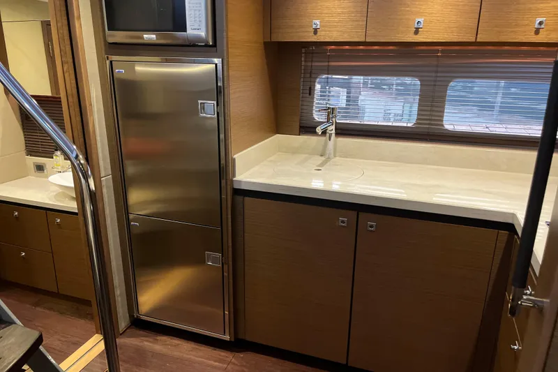 Slide: The Image of Washing machine inside 2015 Sea Ray 510 Sundancer yacht, with open cabinet door. - 23